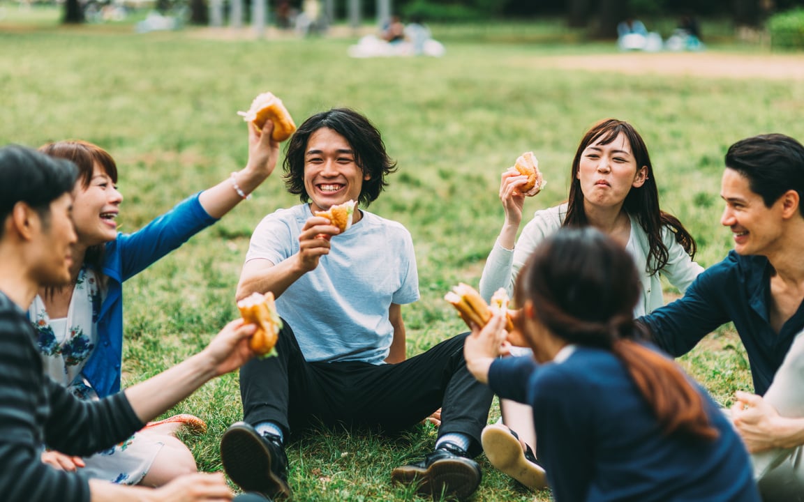 Japanese teenager eating outside